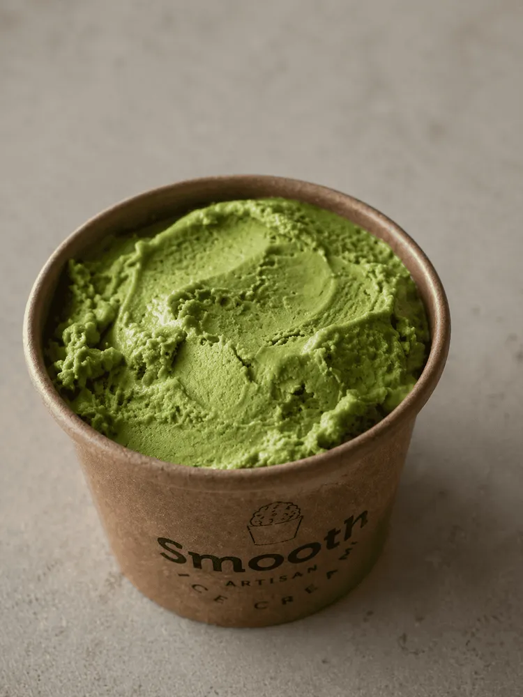 Opened pint of pistachio ice cream showing its texture