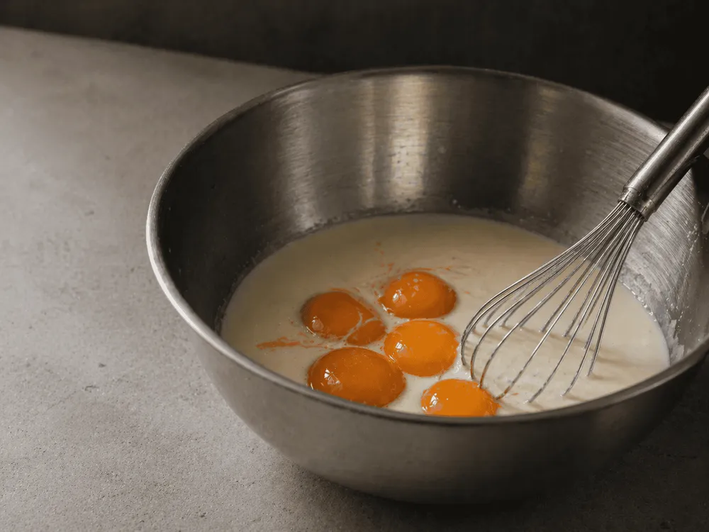 Custard base being whisked before churning